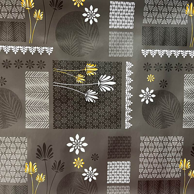 Toile cirée motifs floraux et géométriques sur fond gris foncé vendue au  mètre en 140 cm de large